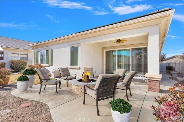 view of patio featuring ceiling fan and a fire pit