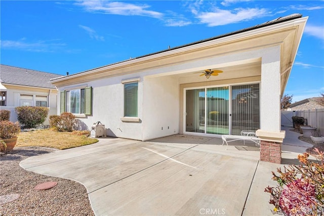 back of property with ceiling fan and a patio