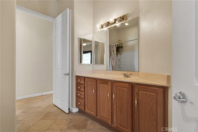 bathroom featuring walk in shower and vanity