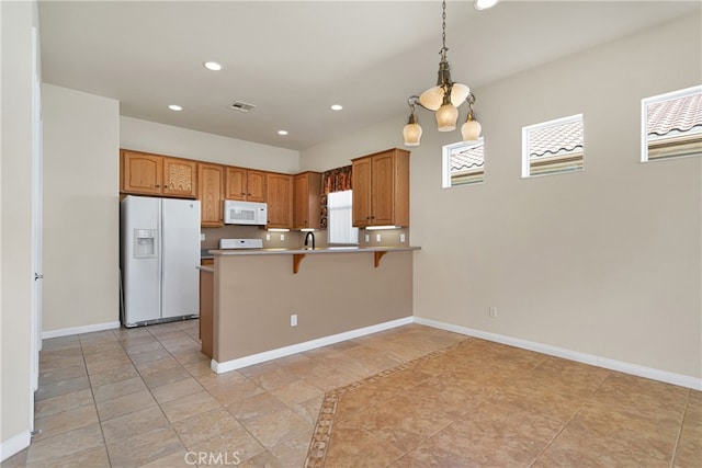 19269 Galloping Hill Rd, Apple Valley, CA 92308 - kitchen featuring white appliances, a peninsula, recessed lighting, plenty of natural light, and a breakfast bar area
