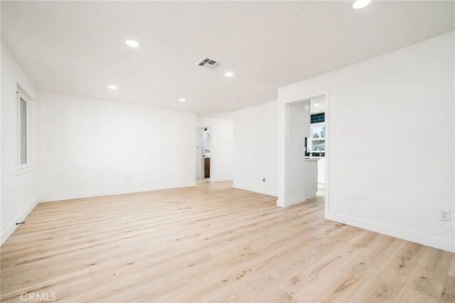 unfurnished room with light wood-type flooring