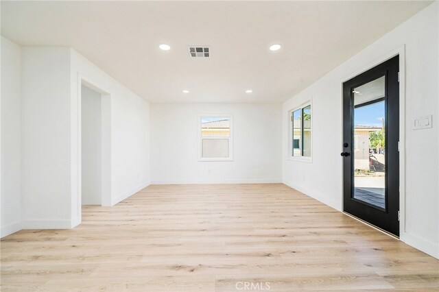 spare room featuring light hardwood / wood-style floors