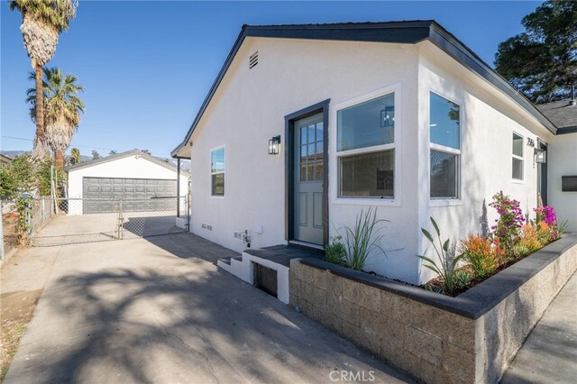 view of front of property with a garage and an outbuilding