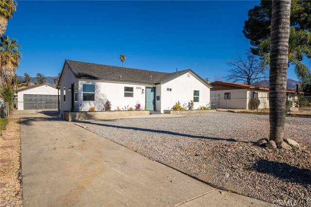 back of house featuring a garage and an outdoor structure