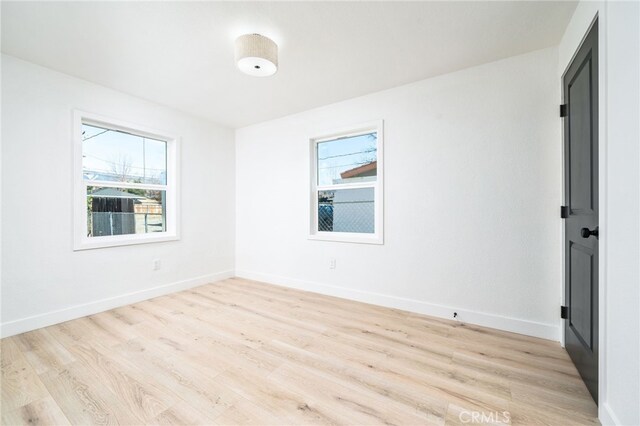 unfurnished room with light hardwood / wood-style floors