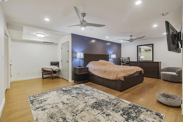 bedroom with ceiling fan and light wood-type flooring