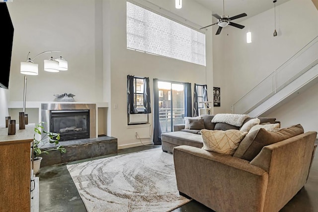 living room with a high ceiling and ceiling fan