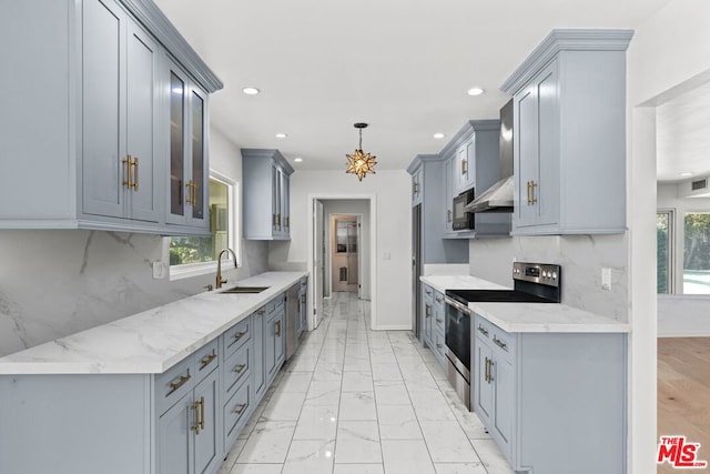 kitchen featuring gray cabinetry, sink, light stone countertops, and stainless steel range with electric cooktop