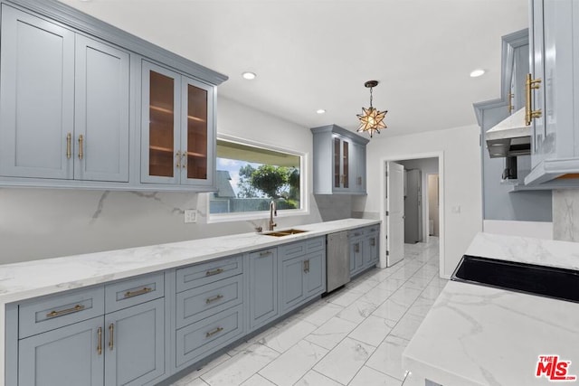 kitchen featuring light stone counters, stainless steel dishwasher, hanging light fixtures, and sink