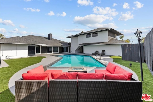 view of swimming pool with outdoor lounge area, a yard, and a patio