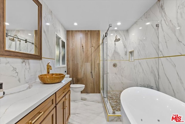 full bathroom featuring vanity, toilet, shower with separate bathtub, and tile walls