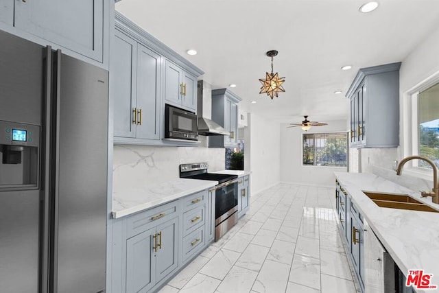 kitchen featuring ceiling fan, sink, stainless steel appliances, backsplash, and pendant lighting