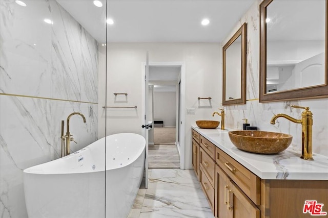 bathroom with a washtub and vanity