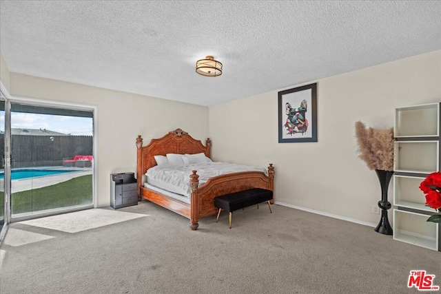 bedroom featuring carpet flooring and a textured ceiling