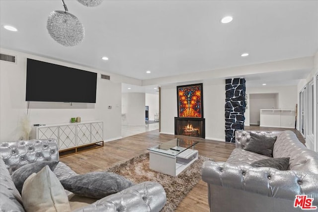 living room featuring a fireplace and light hardwood / wood-style floors