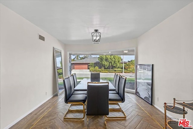 dining space featuring wine cooler, plenty of natural light, parquet floors, and an inviting chandelier