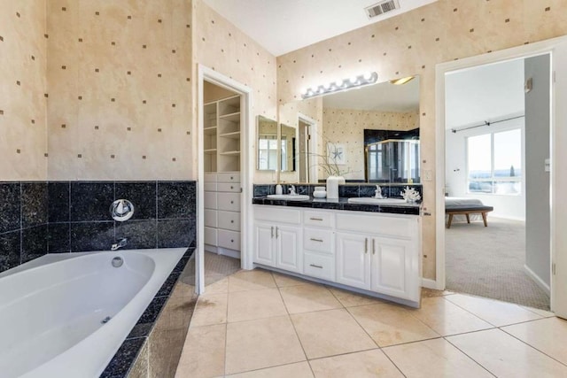 bathroom featuring tile patterned floors, vanity, and independent shower and bath