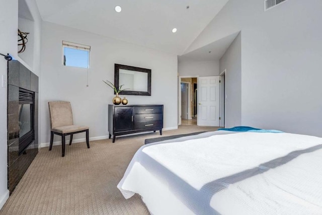 carpeted bedroom featuring high vaulted ceiling