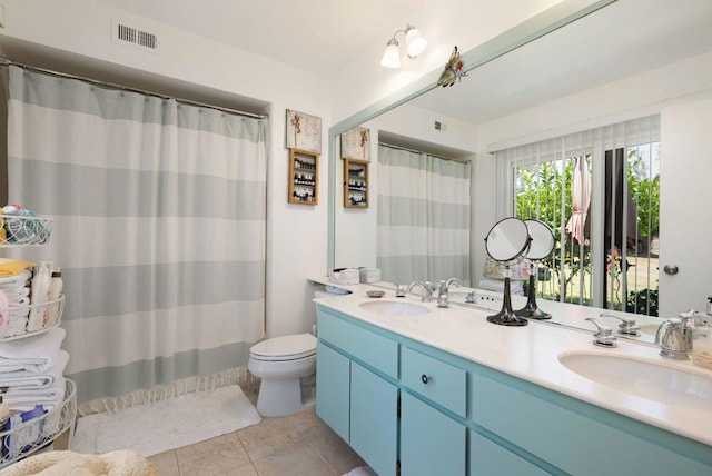 bathroom featuring tile patterned floors, vanity, and toilet