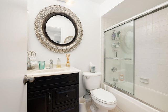 full bathroom featuring bath / shower combo with glass door, toilet, and vanity