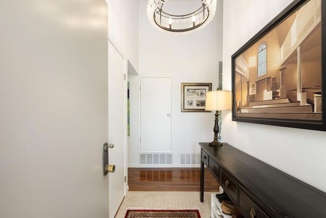 interior space with a towering ceiling and light tile patterned flooring