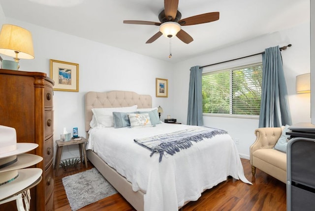 bedroom with ceiling fan and dark hardwood / wood-style floors