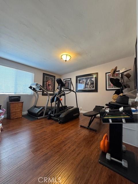 workout area with wood-type flooring