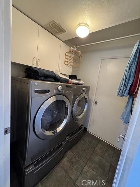 clothes washing area with cabinets and independent washer and dryer