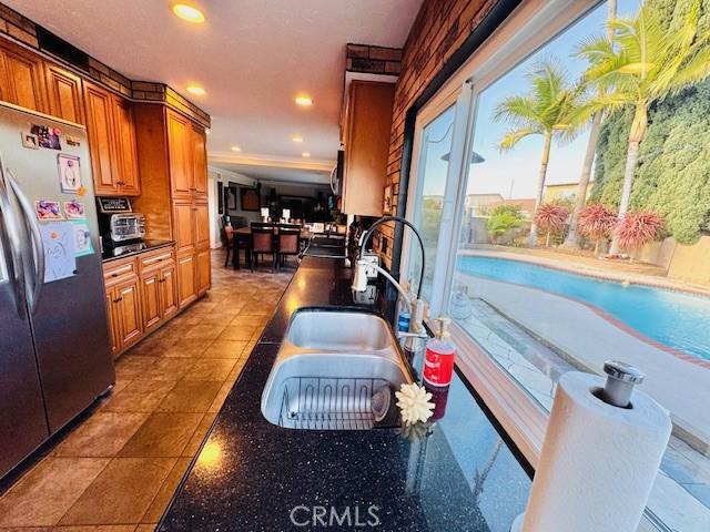 interior space featuring stainless steel refrigerator and sink