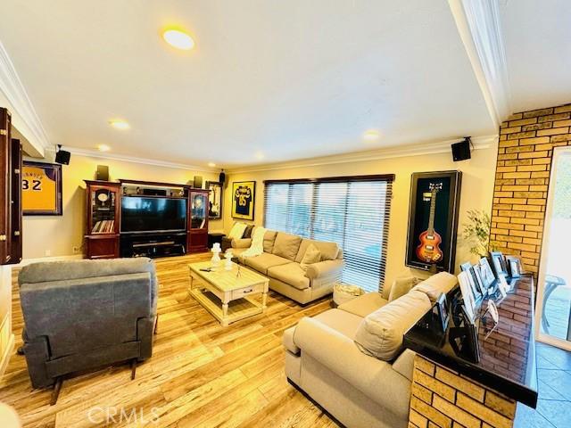 living room featuring light hardwood / wood-style floors and ornamental molding