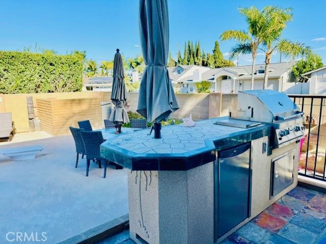 view of patio featuring area for grilling and a bar