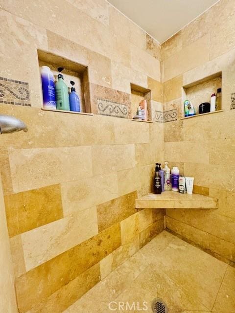 bathroom with a tile shower