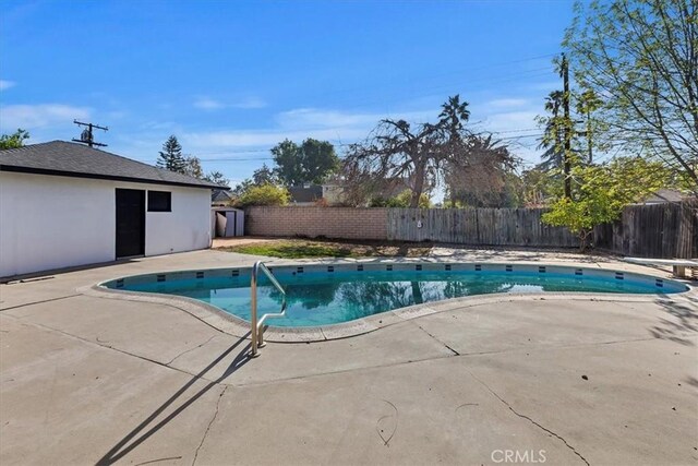 view of swimming pool featuring a patio area