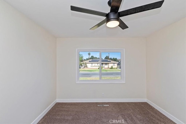 carpeted spare room with ceiling fan