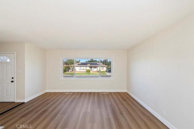 empty room with hardwood / wood-style floors