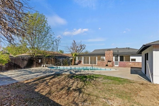 view of swimming pool featuring a patio area and a lawn