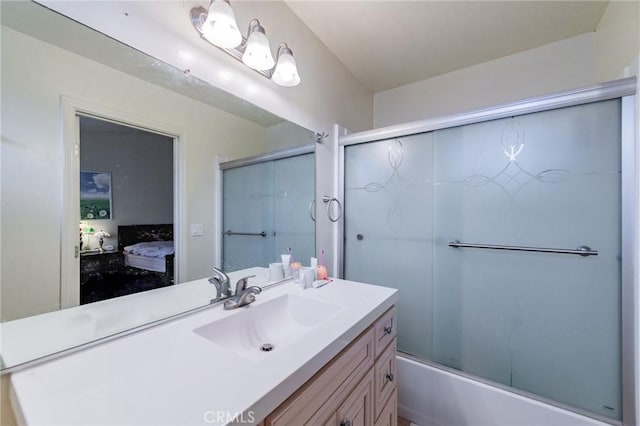 bathroom featuring vanity and shower / bath combination with glass door