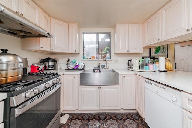 kitchen with white dishwasher, sink, stainless steel range with gas stovetop, and white cabinets