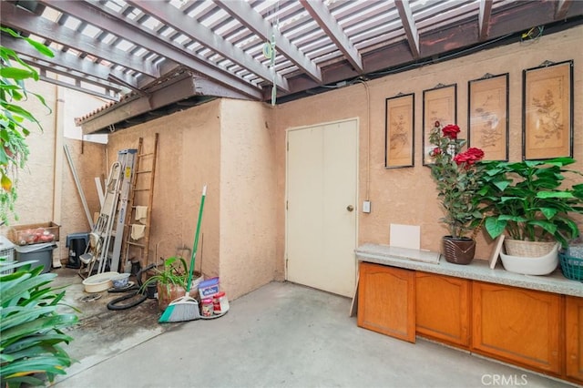 doorway to property featuring a pergola and a patio area