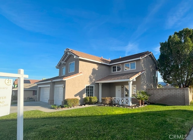 traditional home with driveway, stucco siding, an attached garage, and a front yard