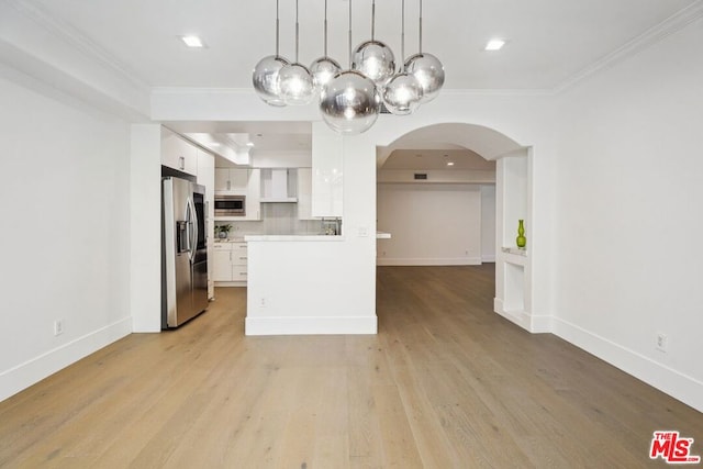 kitchen featuring white cabinetry, appliances with stainless steel finishes, and crown molding