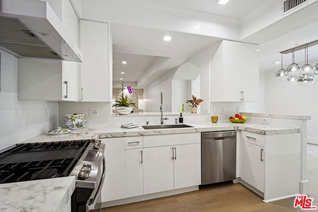 kitchen with light stone countertops, white cabinets, stainless steel appliances, ventilation hood, and kitchen peninsula