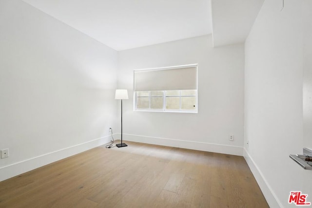 spare room with hardwood / wood-style flooring