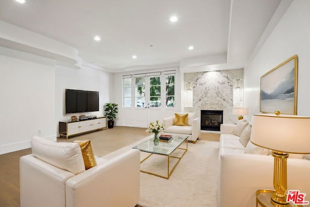 living room with wood-type flooring and a fireplace