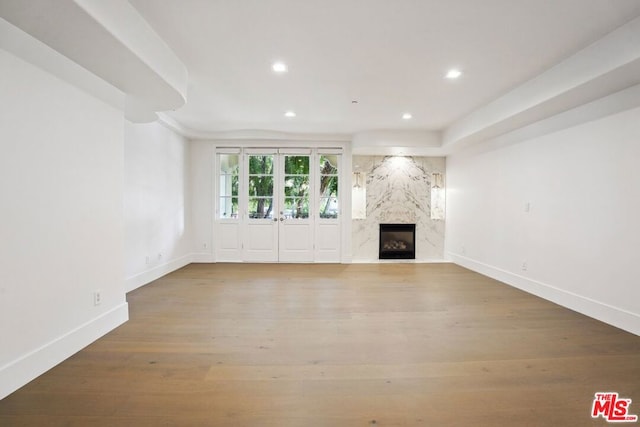 unfurnished living room with wood-type flooring and a fireplace