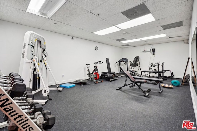 workout area featuring a paneled ceiling