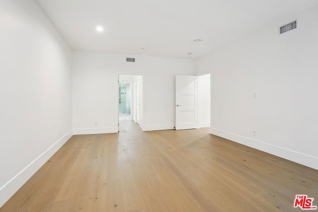 spare room featuring light wood-type flooring