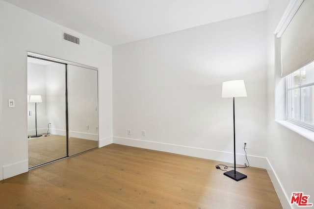 unfurnished bedroom with hardwood / wood-style floors