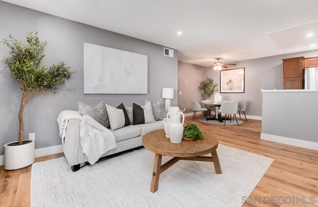 living room featuring ceiling fan and wood-type flooring