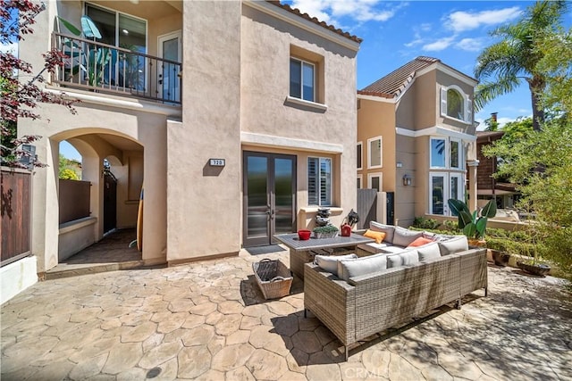 view of patio / terrace featuring a balcony, outdoor lounge area, and french doors